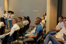a man standing in front of a room full of people