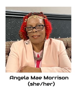 Angela is a black mid fat woman, her hair is red and she is wearing glasses.