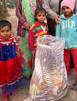 poor children accepting ration kits