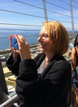 Lady snaps a picture atop the Space Needle in Seattle, Washington