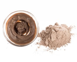 a jar of chocolate pudding with a spoon and a spoon
