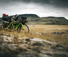 Loaded bicycle in mountains by Marek Piwnicki