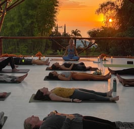 a group of people doing yoga in a large open space