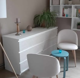 a living room with a white chair and a table