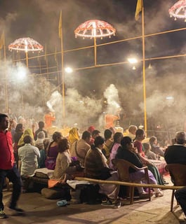 People taking part in a religious ceremony on the ghats of Varanasi, India.