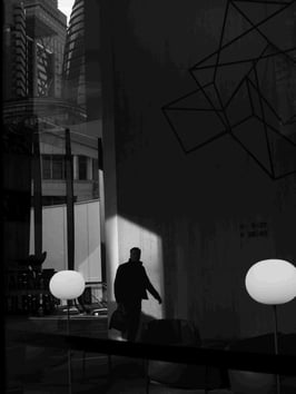 A man is silhouetted against sunlight.
