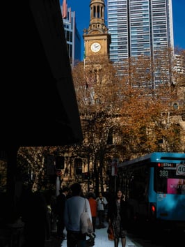View of Sydney Town Hall with pedestrians in the foreground.