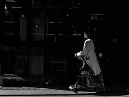 Stylishly-dressed woman walking along street in Surrey Hills, Sydney