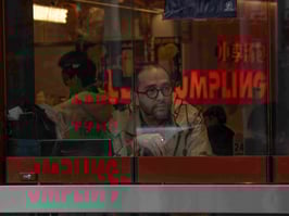 Man sitting in Chinese cafe in China Town, Sydney.