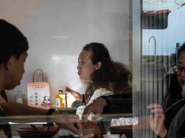 Sun highlights a woman in Chinese restaurant in Sydney's China Town.