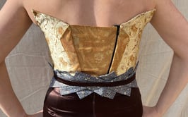 The back of a gold brocade and brown satin evening gown