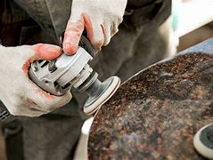 Photos of the application of abrasives in stone processing.