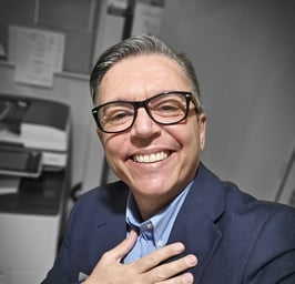a man in a suit and tie smiling