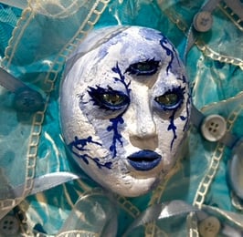 a painting of a face with a blue face and tissus and three eyes