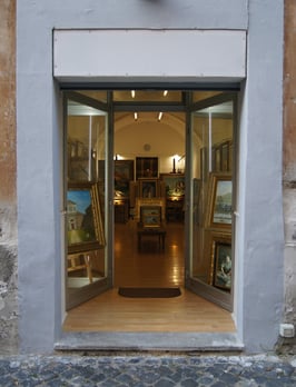 a doorway with a door open to a room with art work