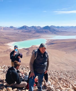Group photo during the ascent of Licancabur volcano with Laguna Verde in the background.