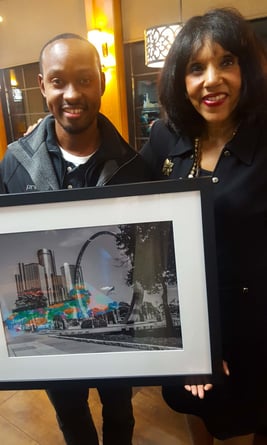 Photographer Gary Washington with art collector holding Arcs of Labor art.