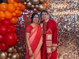 Couple in front of the rose gold shimmer wall, garland and neon sign for their annivesary in Brisbane.