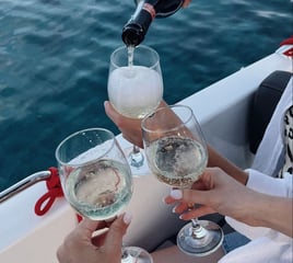 Guests toasting at sunset during a romantic boat tour with Balea Charters in Mallorca