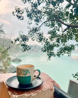 Taking a chai tea break by the Ganges river surrounded by nature in Rishikesh, India.
