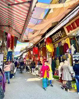 Vibrant street market in Rishikesh, India, filled with colorful stalls, local goods, and lively atmosphere.