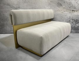 Modern bench with plush cream cushions and gold metal back, by Solo Home Decor.