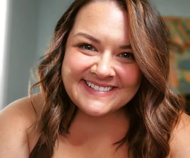 Caucasian woman smiling at camera; brown hair