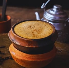 a cup of coffee with a teapot and a teapot