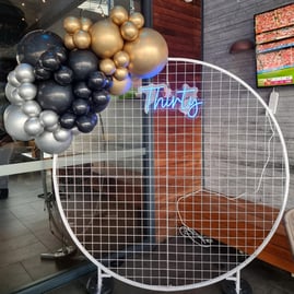 White circle mesh backdrop with a mini baloon garland and Thirty neon sign at the Chatswood Hill Tavern