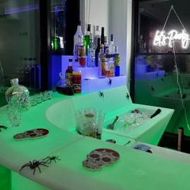 Glow corner bar setup with let's party neon in the backdround at hire event in Redlands.