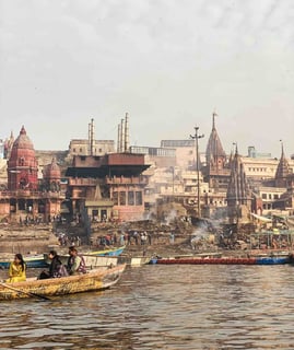 Traditional Hindu cremation ceremony taking place at Manikarnika Ghat in Varanasi, on the banks of the sacred Ganges River.