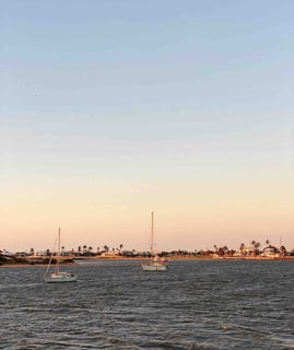 Boats anchored in Carnarvon Bay at sunset, Western Australia.