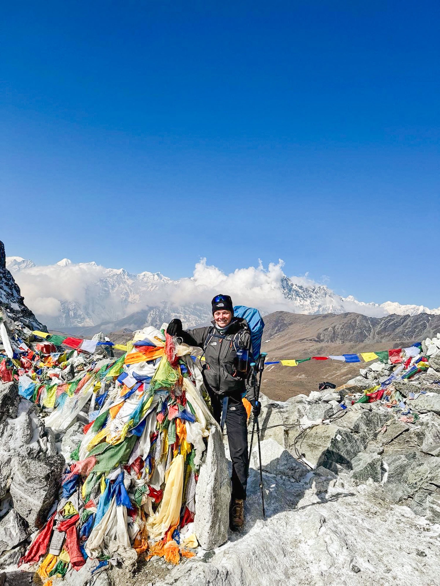 Photo of me at the top of Cho La Pass, surrounded by Nepali prayer flags.
