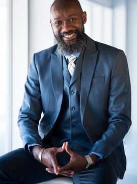 a man in a suit and tie smiling