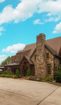 a large house with a driveway and garage