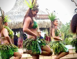 Tahitians dressed in traditional attire during a local dance in Tahiti, French Polynesia.