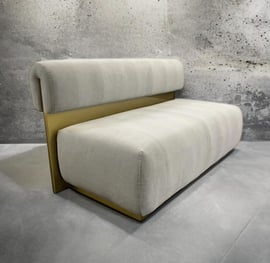 Modern bench with plush cream cushions and gold metal back, by Solo Home Decor.