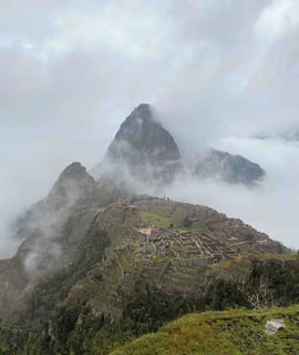 Machu Picchu surrounded by clouds in Peru.