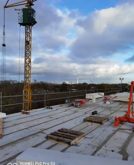 a crane is standing on a roof top