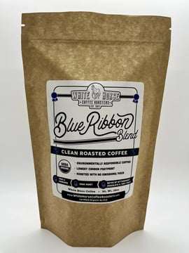 A brown bag with a logo saying White Horse Coffee Blue Ribbon Blend
