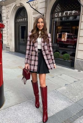 a woman in a plaidered jacket and knee high boots