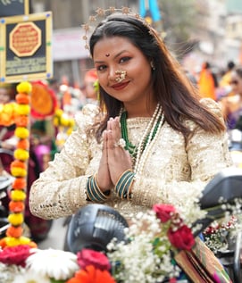 woman in maharastrian traditional outfit riding a motorbike in girgaon gudipadwa shobhayatra 2025