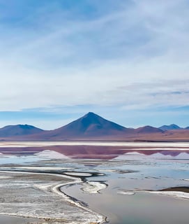 Colorful lagoon in the South Lípez region with vibrant hues of red, and turquoise.