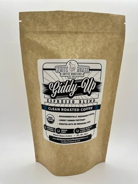 A brown bag with a logo on it from White Horse Coffee, the logo says Giddy Up Espresso Blend