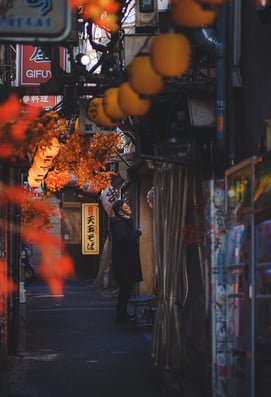 Elvin Mendoza captures the vibrant, bustling streets of Shinjuku, Tokyo where a man is smoking.