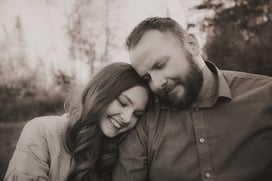Father and teenage daughter share a tender moment as she rests her head on his shoulder during a Dul