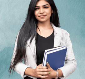 "Teacher standing with books in hand, ready to guide students in their learning."