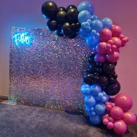Irididescent shimmer wall and fifty neon with balloons for Mary's 50th birthday in Redlands.
