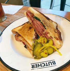 a sandwich with pickles on a plate