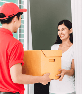 a man and woman holding a box of boxes